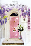 This image portrays a welcoming East Sheen front door adorned with romantic, pastel-toned florals, ideal for marking the joy of a new home. In the centre stands a pale pink door, its colour warm and comforting, with a smooth finish that gently reflects the ambient daylight. The surrounding wall is whitewashed, simple but characterful, creating a clean canvas that lets the subtle hues of the scene stand out. Overhead and along the side, wisteria flows in soft cascades, its blossoms a blend of lavender, lilac, and dusty purple, hanging in loose, fragrant garlands that frame the doorway like a natural curtain. Light filters through the flower clusters, scattering faint, dappled shadows across the door and step, evoking the peaceful atmosphere of a quiet side street off Upper Richmond Road in late spring. Sitting right on the threshold is a vintage-style metal bucket filled to overflowing with creamy white roses. Their petals are lush and layered, giving a sense of depth and softness, while sprigs of fresh green foliage weave through the bouquet, adding texture and a hint of wild, garden charm. A delicate pink ribbon is wrapped around the bucket, tied in a modest bow that repeats the gentle blush of the door and creates a clear visual harmony. The composition is simple yet deeply evocative: it feels like a thoughtful floral delivery left for someone returning to their new East Sheen home, perfectly capturing the emotions of anticipation, gratitude, and the comforting sense of finally being home after a long journey, ideal for a new house card or housewarming sentiment.